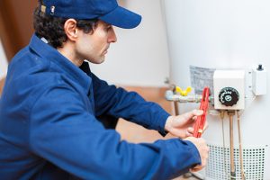 Water Heaters are being repaired by a plumber 